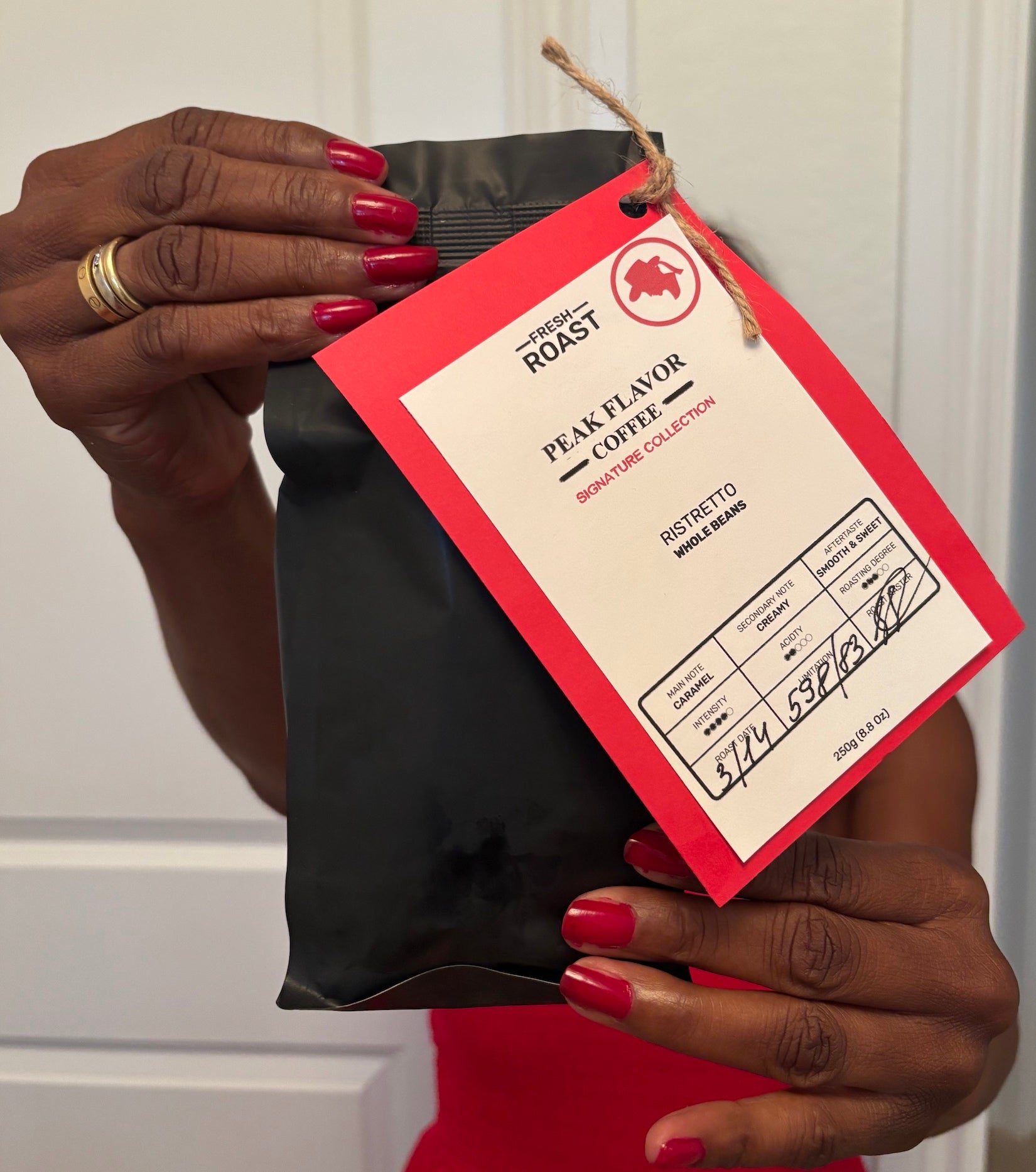 Melicent holds Signature Ristretto Beans