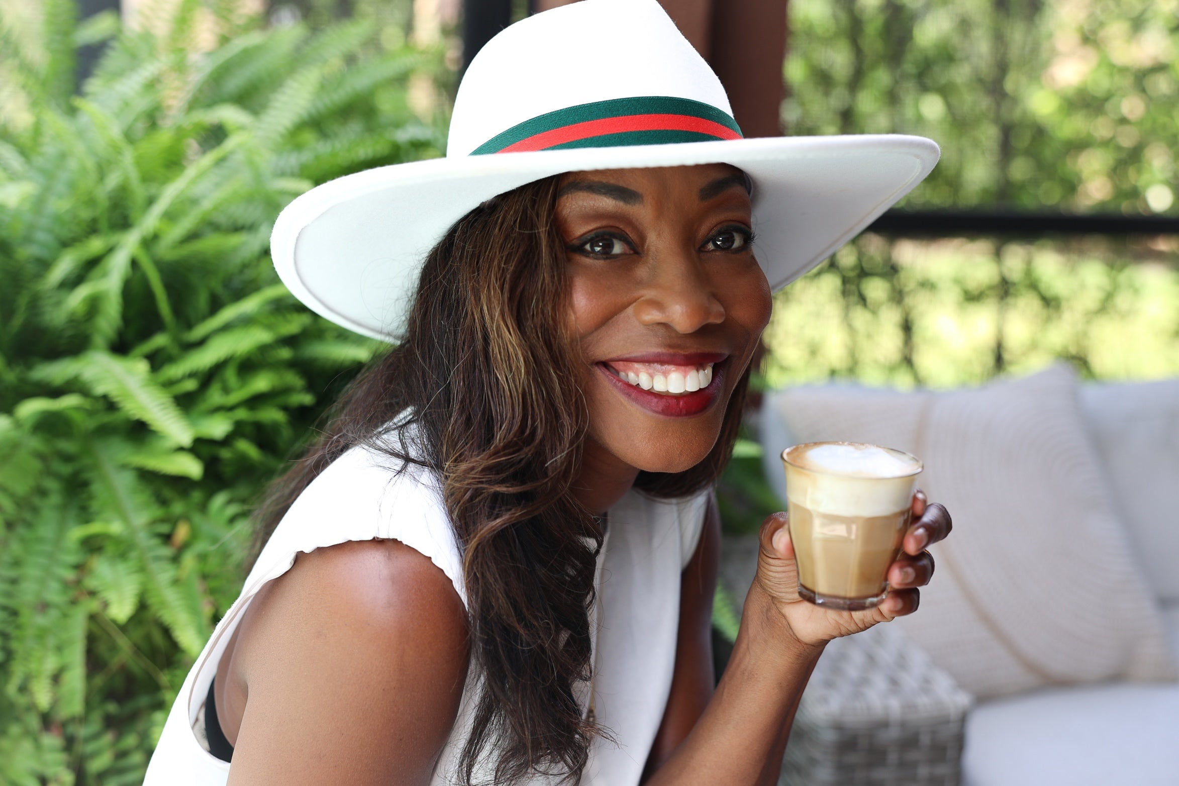 Melicent enjoys a cafe latte