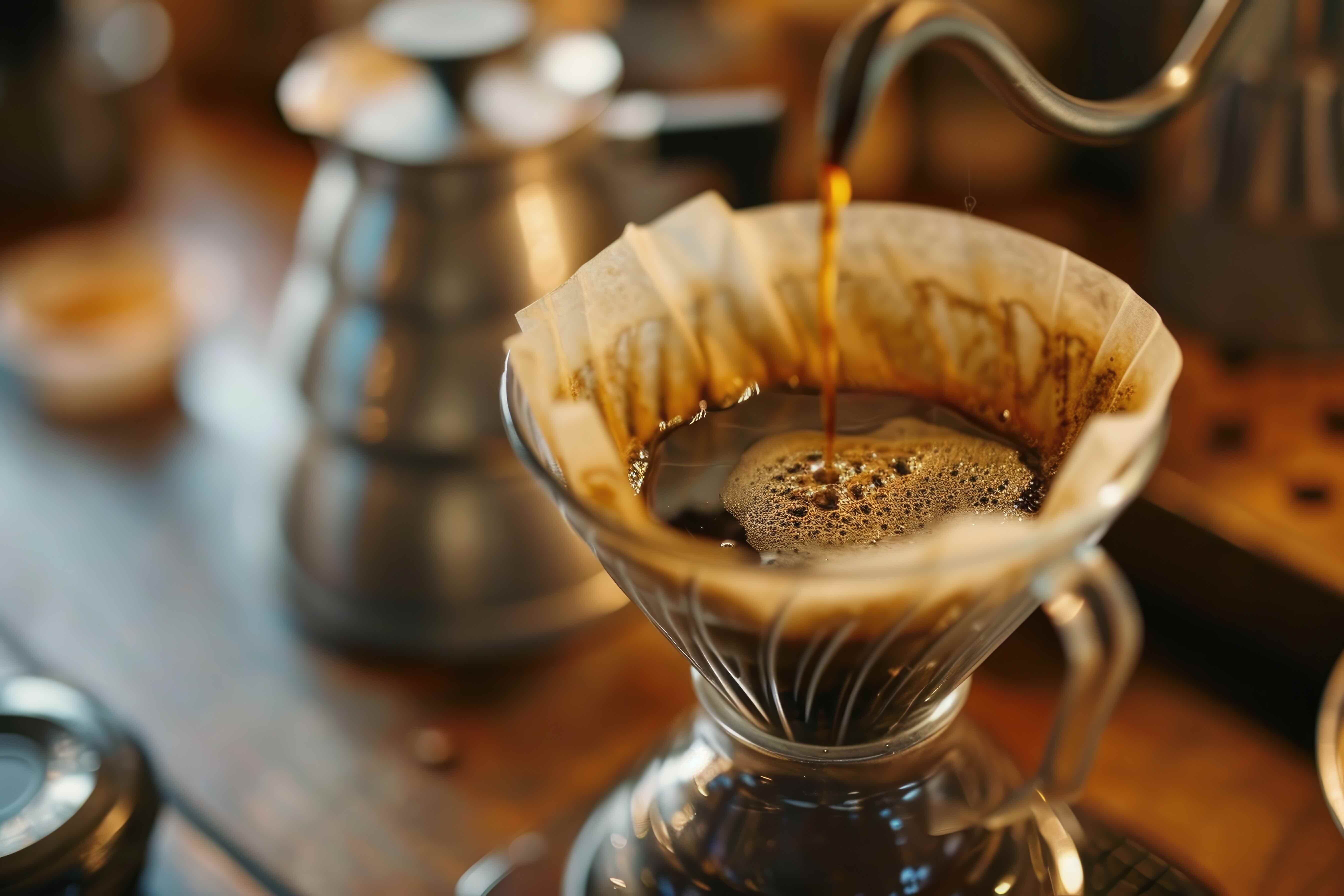 low acid Coffee being poured into a paper coffee filter on a wooden surface