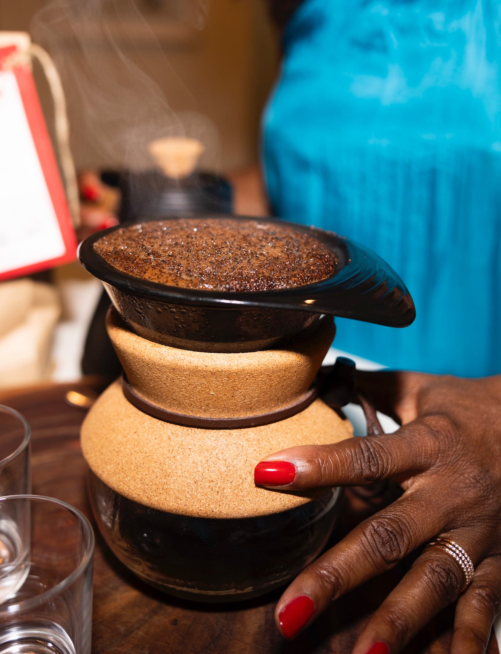 Melicent uses a pour over coffee maker